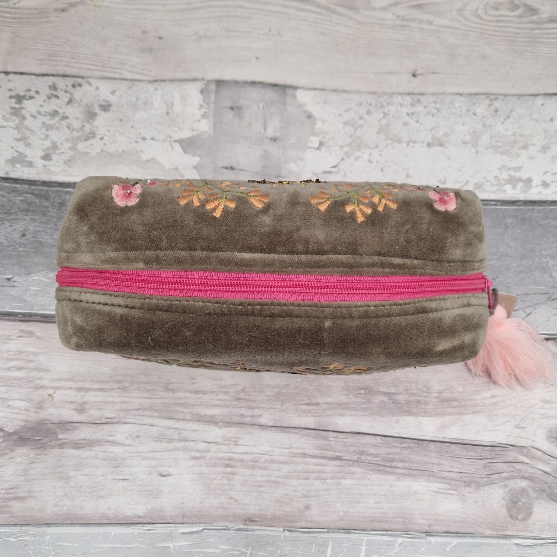 Top down view of our sage coloured velvet wash bag.