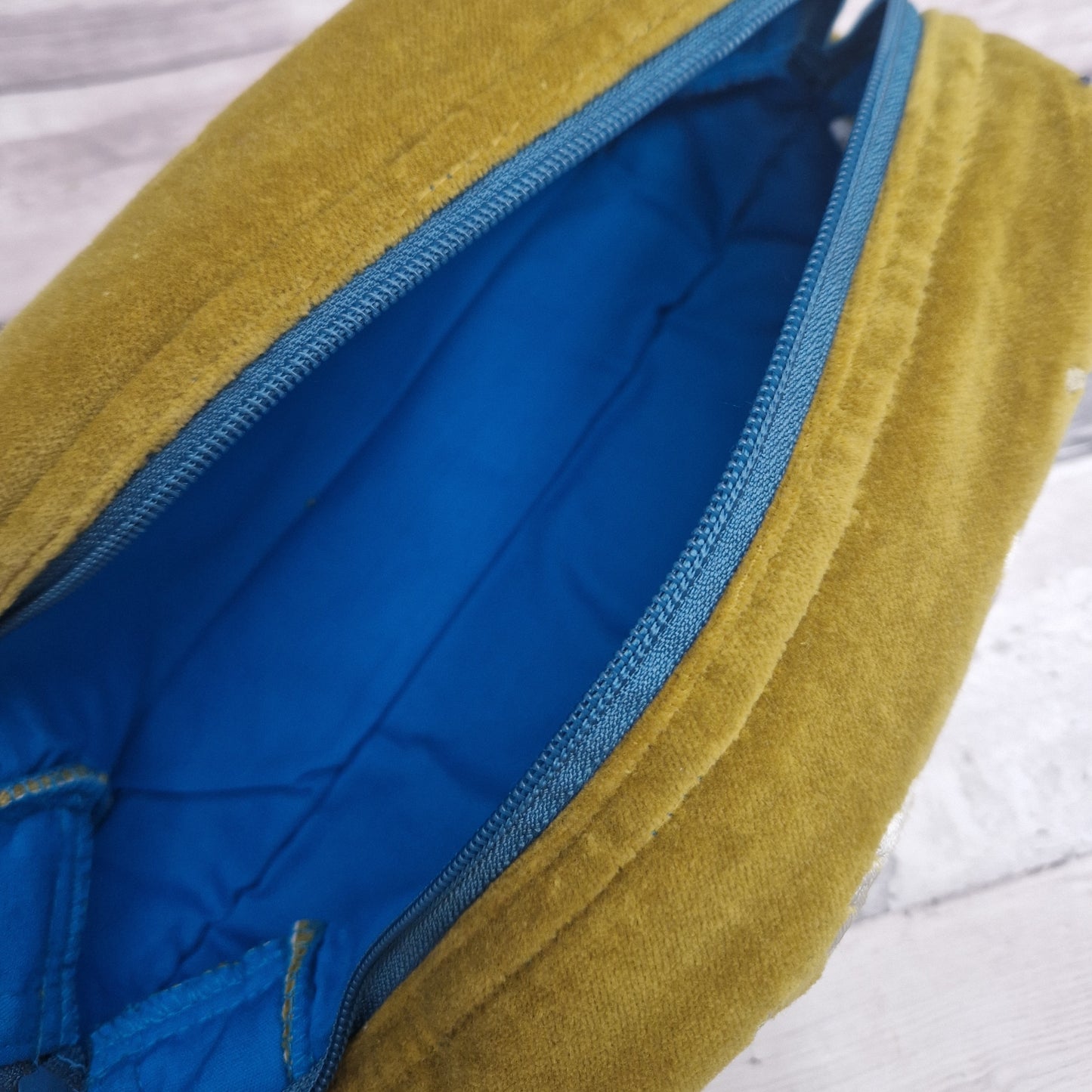 Inside view of wash bag showing a royal blue lining.