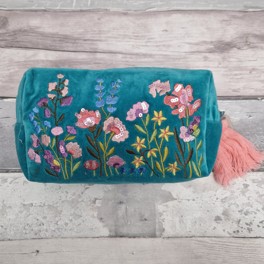 Turquoise coloured velvet wash bag. Hand decorated with embroidery and sequins. Depicting a garden of pretty pink and purple flowers.