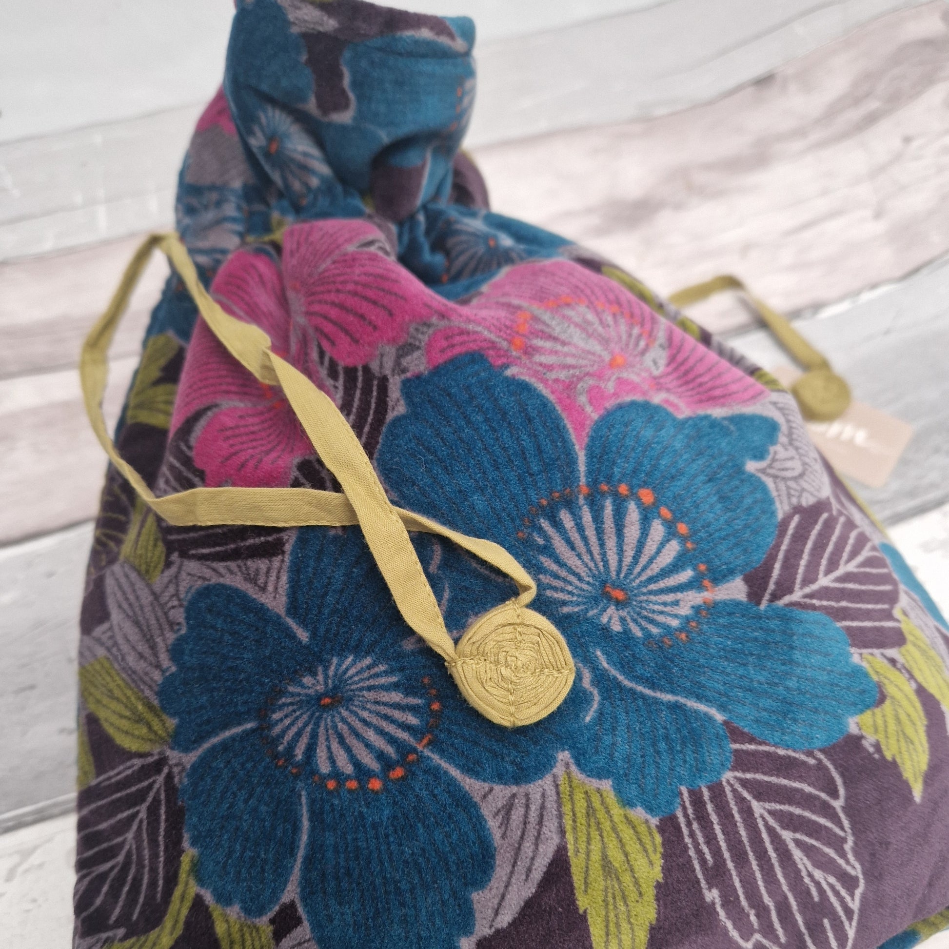 Large drawstring velvet pouch decorated in rich colours depicting an Hibiscus flower garden.