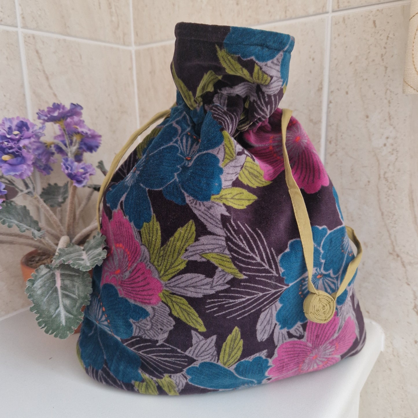 Large drawstring velvet pouch decorated in rich colours depicting an Hibiscus flower garden.