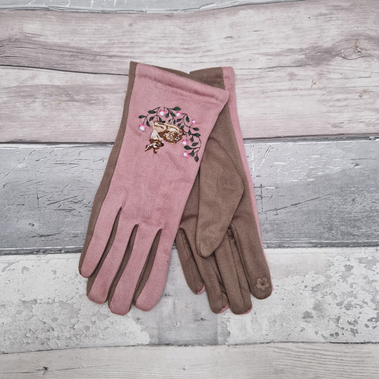 Pink and beige gloves with an embroidered Deer motif on the back of the hand.