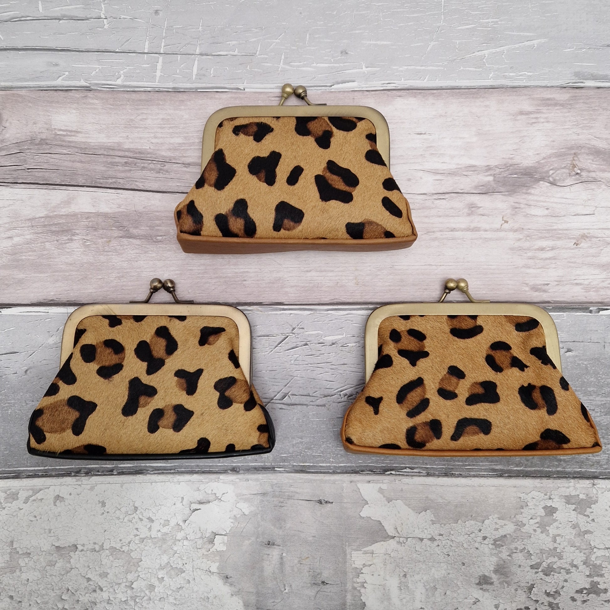 Vintage inspired coin purses with a metal frame and twist lock finished in textured abstract leopard print.