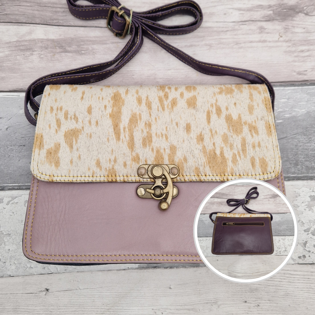 All leather lilac coloured bag with a textured panel of pony print. A brass swivel clasp secured the bag at the front.