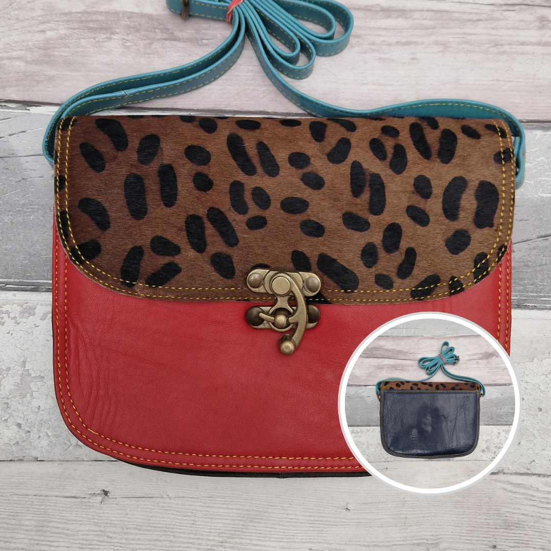 All leather red coloured bag with a textured panel of animal print. A brass swivel clasp secured the bag at the front.