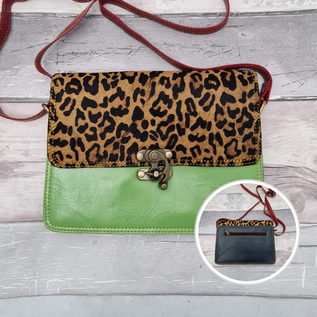 All leather bright green coloured bag with a textured panel of jaguar animal print. A brass swivel clasp secured the bag at the front.