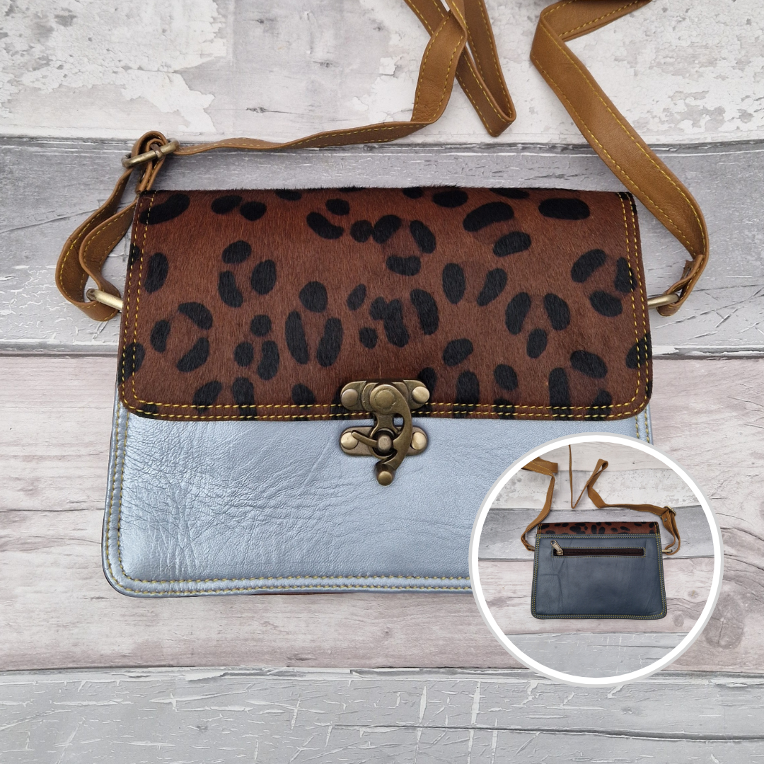 All leather ice blue coloured bag with a textured panel of animal print. A brass swivel clasp secured the bag at the front.