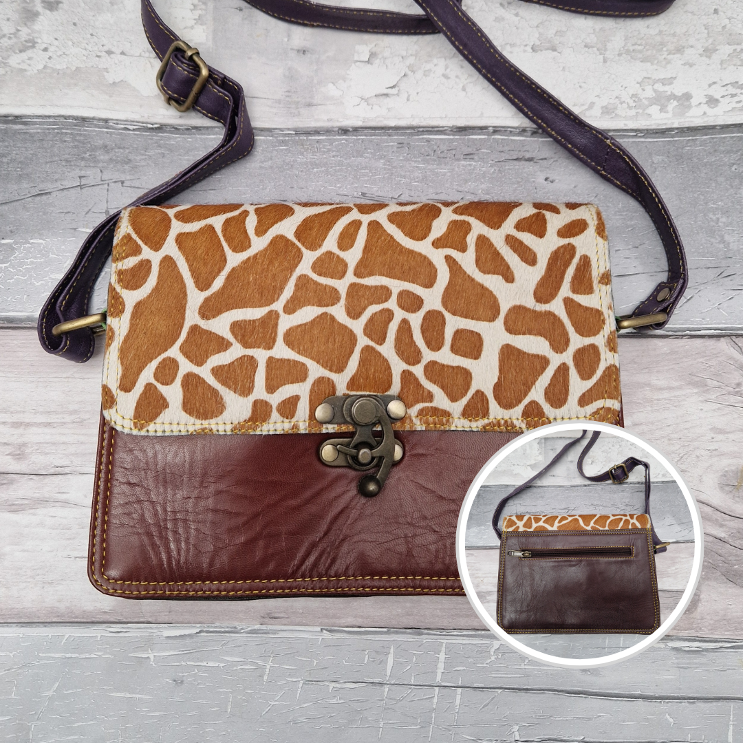 All leather chocolate brown coloured bag with a textured panel of giraffe animal print. A brass swivel clasp secured the bag at the front.