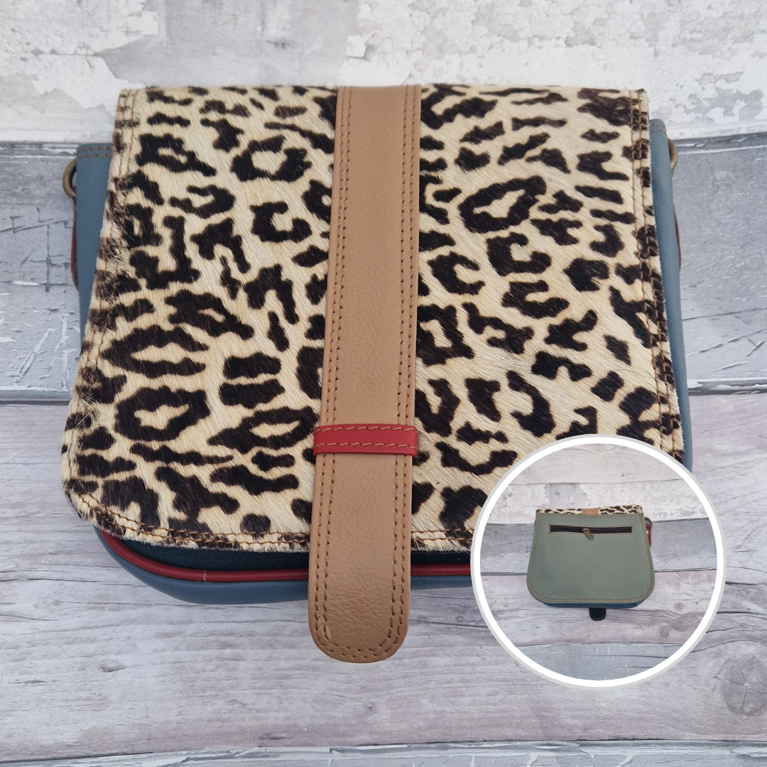 Zoya is a Messenger style bag with a tab on the front to lift for access. She is made from leather off-cuts and is presented in a multitude of colours finished with a large front panel in textured abstract leopard animal print.