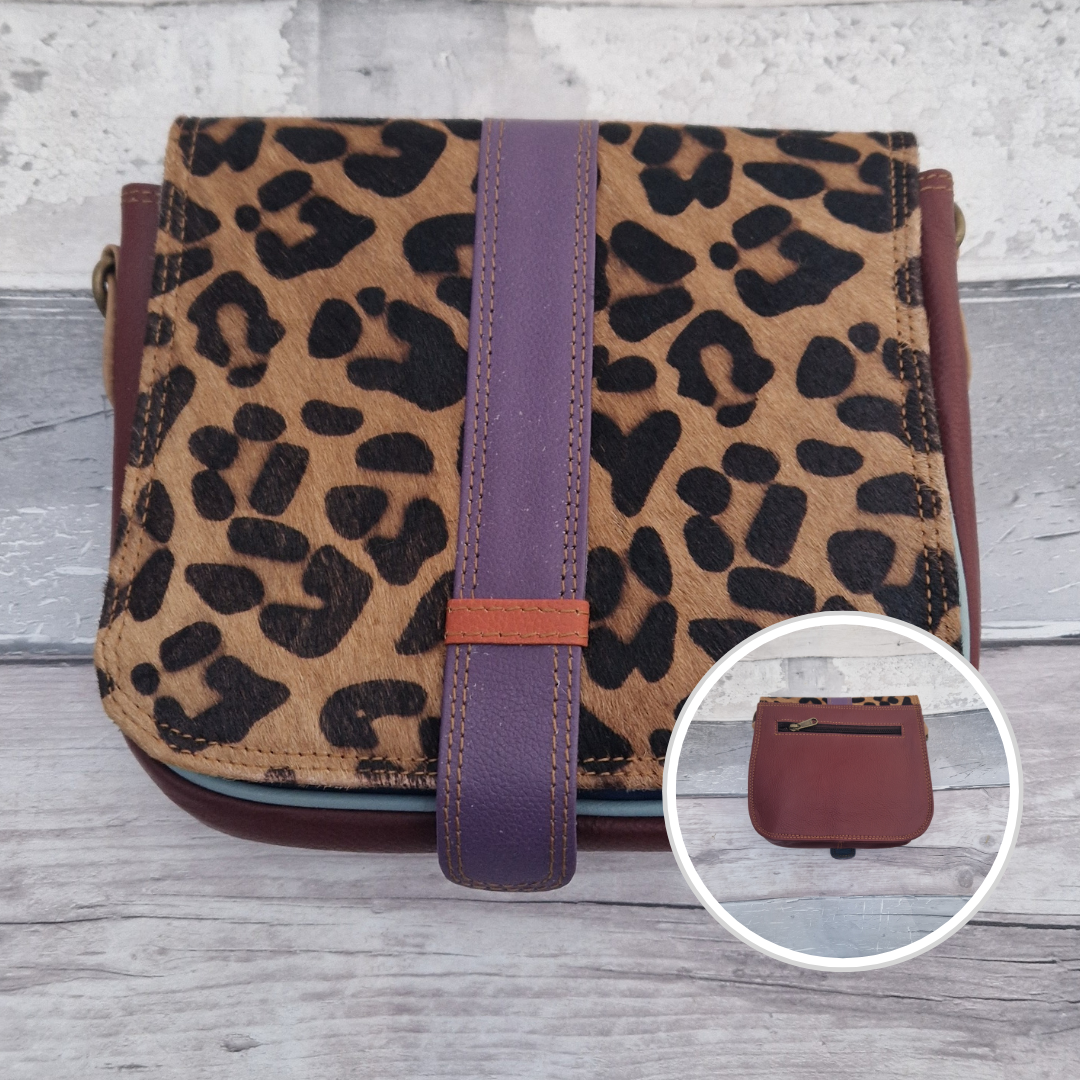 Zoya is a Messenger style bag with a tab on the front to lift for access. She is made from leather off-cuts and is presented in a multitude of colours finished with a large front panel in textured leopard animal print.